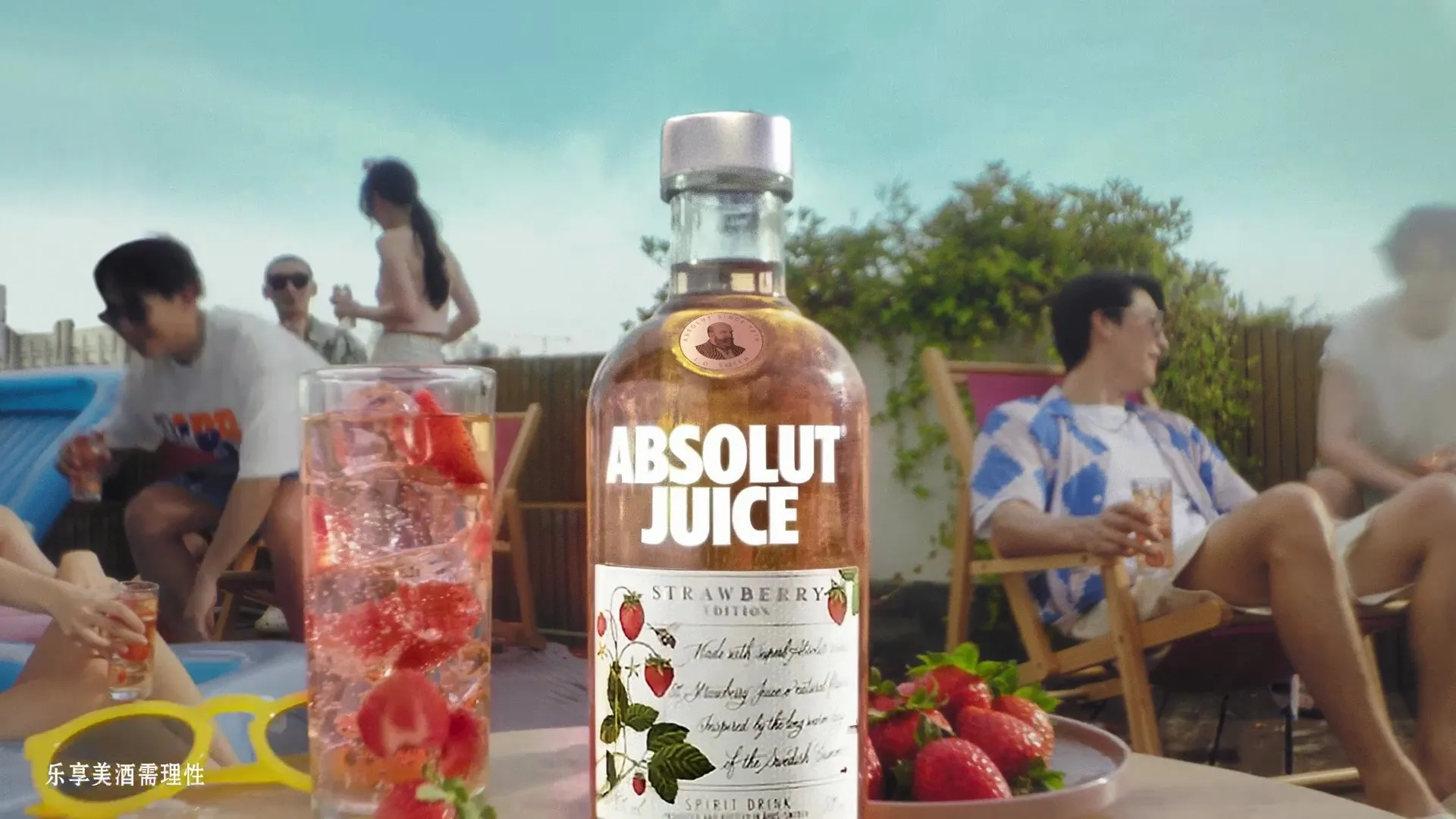 ABSOLUT Juice bottle in a bright poolside campaign scene