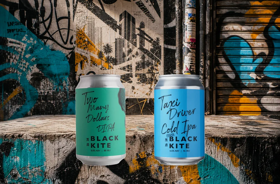 Black Kite green and blue cans against graffiti