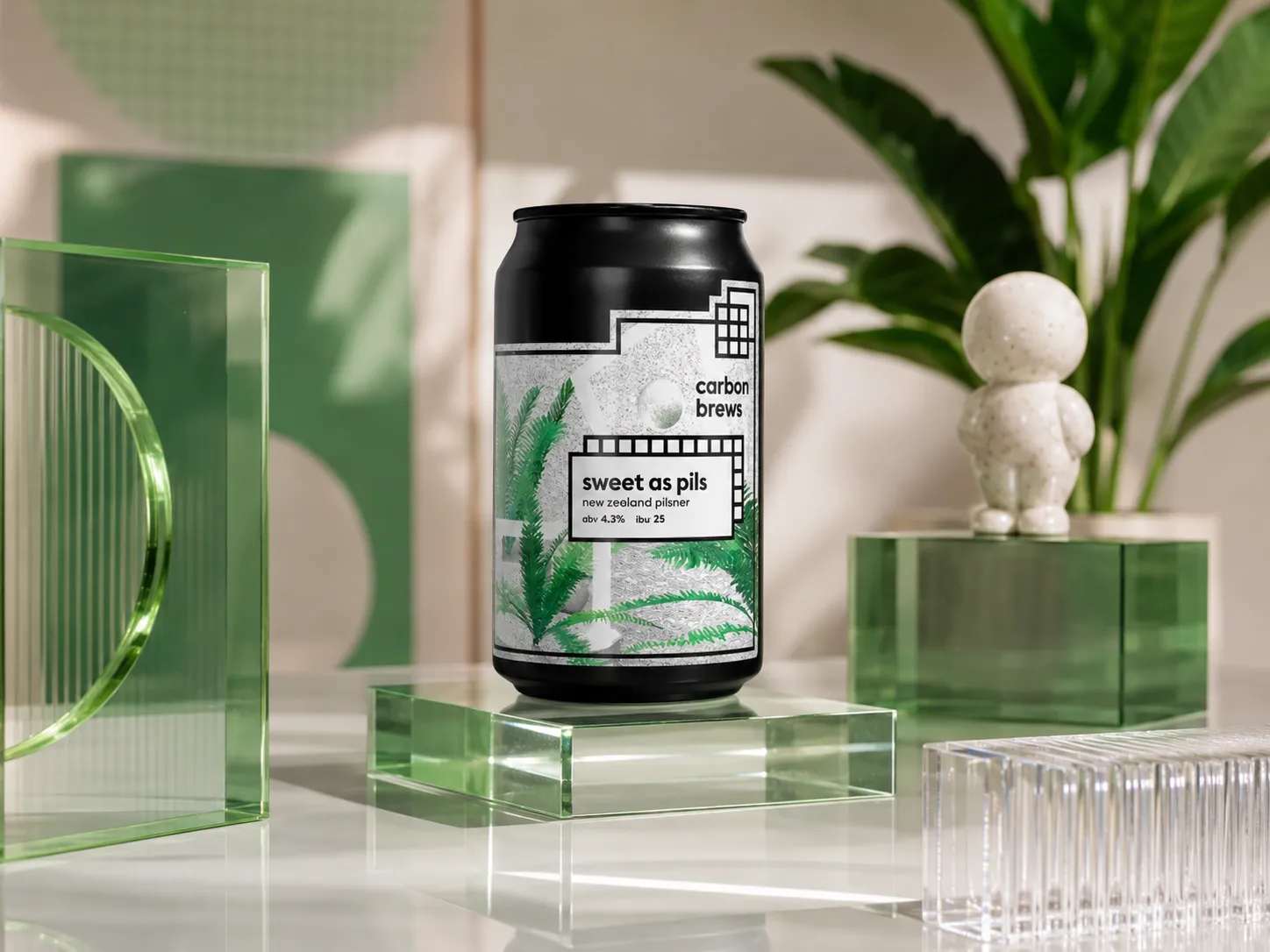 Carbon Brews Sweet As Pils can shown in a green acrylic studio scene