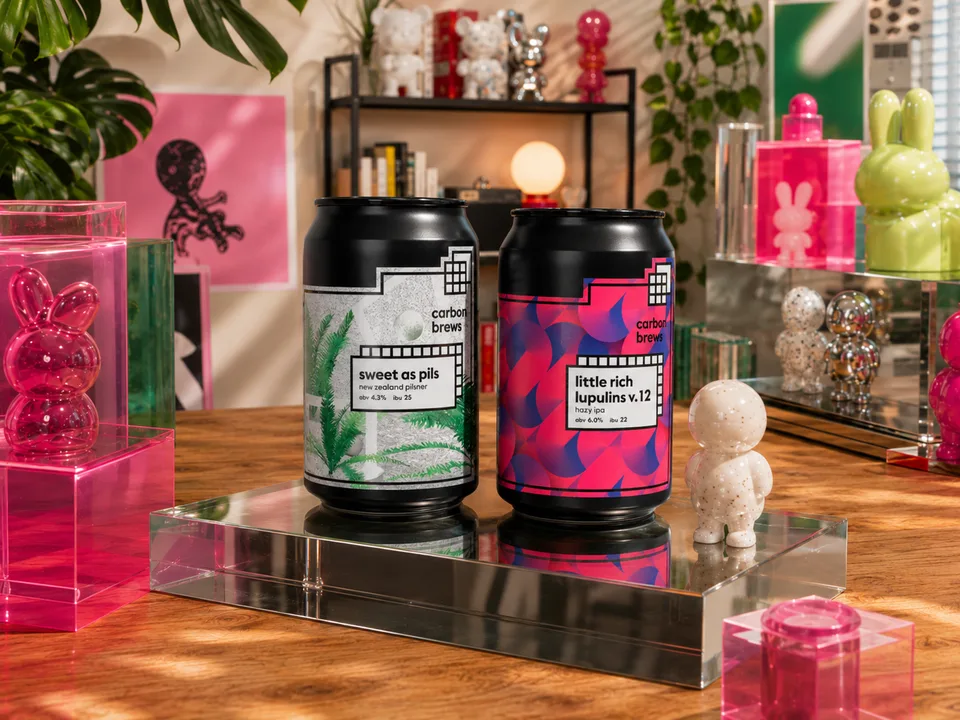 Carbon Brews cans on a reflective tray