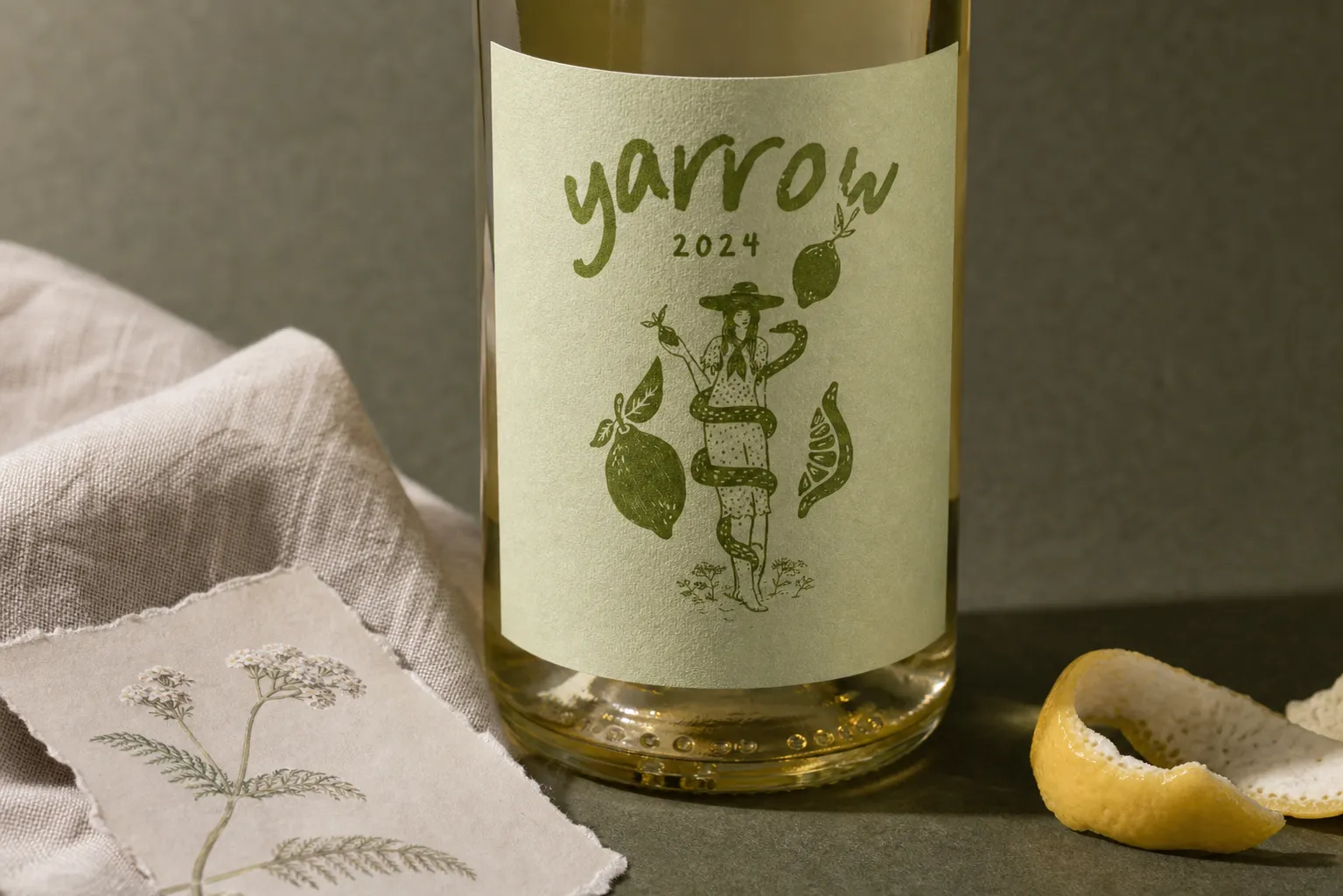 Close label crop showing the Yarrow 2024 Sauvignon Blanc illustration with lemon peel, linen and darker stone tones