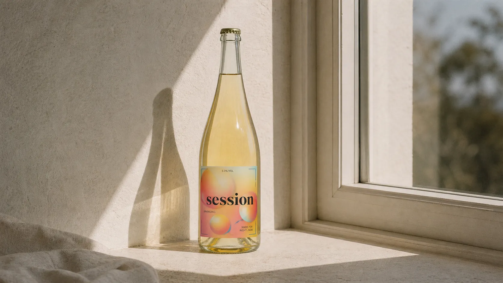 SESSION WINE bottle standing fully on a pale window ledge with afternoon light and film grain