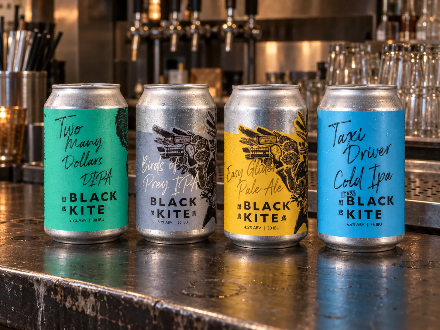 Black Kite four-can range photographed on a used Hong Kong bar counter