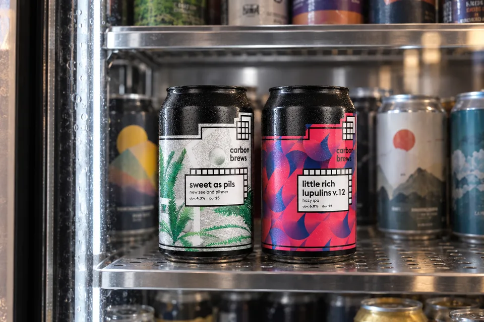Carbon Brews beer pair photographed in a Hong Kong independent bottle-shop refrigerator