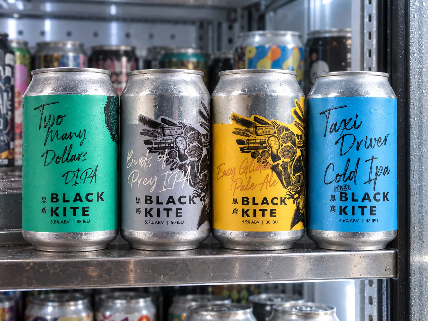 Four complete Black Kite cans photographed on a used independent Hong Kong bottle-shop refrigerator shelf